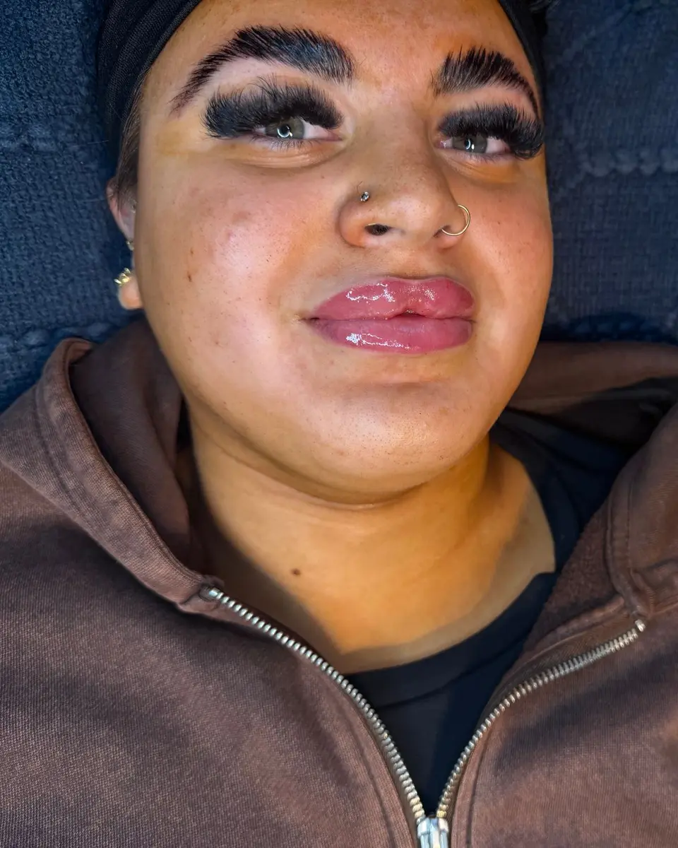 Client with full, brushed-up brows and glossy lips